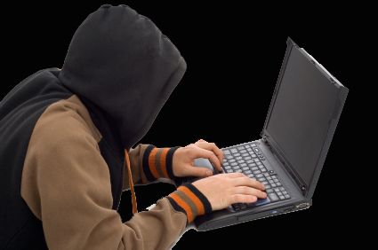 Hacker in the front of a laptop computer